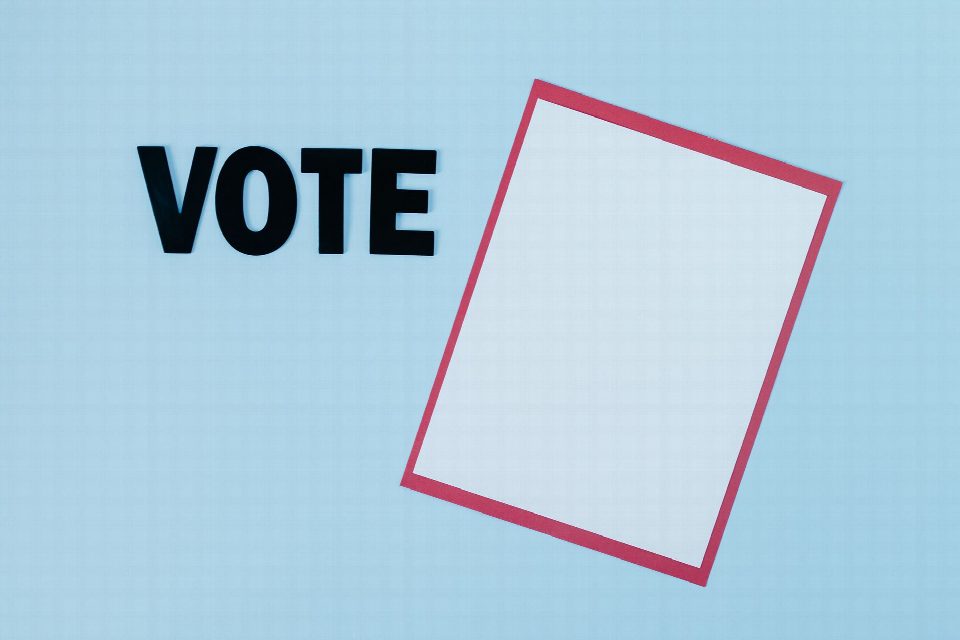 Simple conceptual image featuring the word 'VOTE' and blank paper, ideal for election themes.